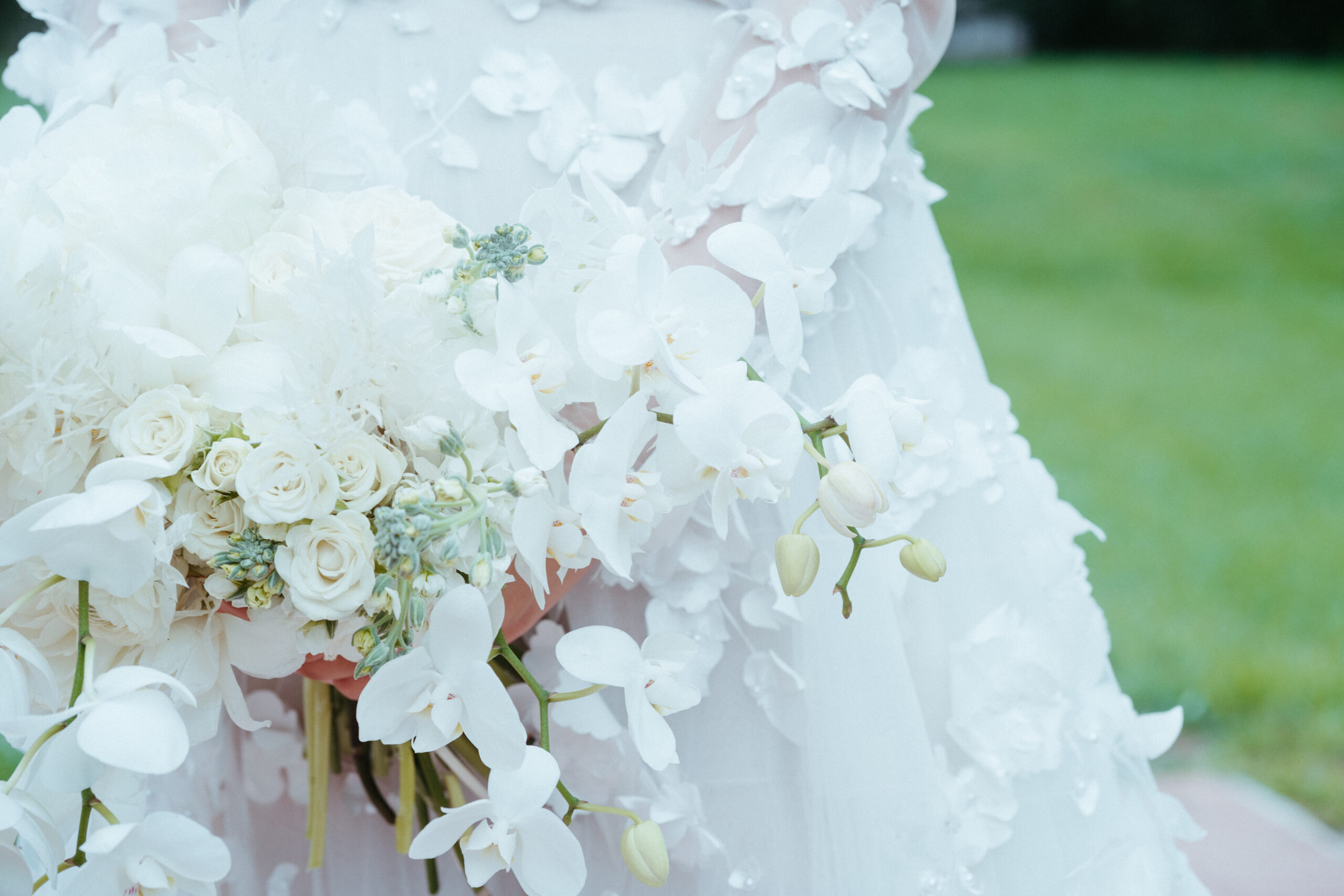 close up image of brides flowered textured gown with beautiful florals